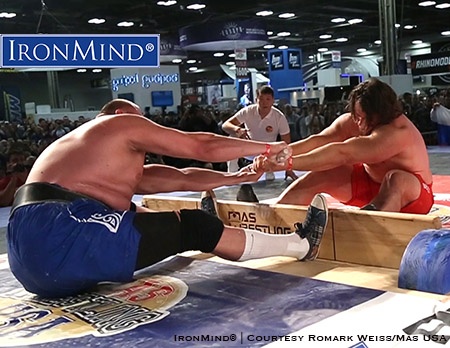 Martins Licis (right) is a favorite to bring back a gold medal from the Mas Wrestling World Championships. The object in mas wrestling is to either pull the stick from your opponent’s hands or to pull your opponent over the center board. IronMind® | Courtesy Romark Weiss/Mas USA