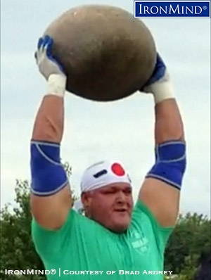 Brad Ardey banged out 9 reps on the overhead press with this 200-lb. manhood stone, en route to winning the final qualifier for the 2017 IHGF All-American Stones of Strength Championships. IronMind® | Photo courtesy of Brad Ardrey