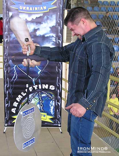 Vyacheslav Gorbunov, vice president of the Ukrainian Armlifting Federation, demonstrates his hand at the CoC Silver Bullet Hold.  IronMind® | Photo courtesy of the Ukrainian Armlifting Federation.