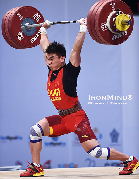 Liao Hui (China) came into this meet with the world record in the jerk and the total in the 69-kg class, and at the World Weightlifting Championships tonight, he added the snatch world record to his collection and pushed up his world record in the total, too, when he made this 193-kg clean and jerk on his second attempt. IronMind® | Randall J. Strossen photo