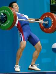 Shi Zhiyong (China) reverses directions and starts pulling himself under his 152.5 kg snatch. IronMind® | Randall J. Strossen, Ph.D. photo