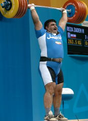 Showing complete domination of his world record clean and jerk, Hossein Rezazadeh casually held it overhead, roaring his satisfaction. IronMind® | Randall J. Strossen, Ph.D. photo.