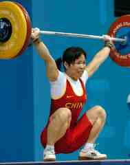 Gold medalist Chen Yanqing (China) hits 107.5 kg on her second attempt in the snatch for a new Olympic record in the women's 58-kg category. IronMind® | Randall J. Strossen, Ph.D. photo.