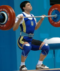 Sailing under the bar on what was the gold medal lift, Nataliya Skakun (Ukraine) nailed this clean and jerk for an Olympic record, along with the gold medal. IronMind® | Randall J. Strossen, Ph.D. photo.