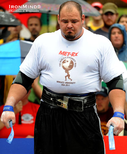 Not distracted by the rain or intimidated by the 442-kg deadlift at his feet, Brian Shaw psyches up at the 2011 World’s Strongest Man contest.  Colin Bryce calls Shaw, “the hottest property in the strength world,” and you can see him in person at Giants Live in Melbourne, Australia on March 17–18.  IronMind® | Randall J. Strossen photo.