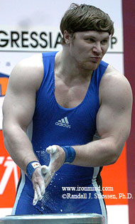 Weighing a little under 122 kg, MILO coverguy Evgeni Chigishev (Russia) chalks up for a crack at a 210.5-kg snatch at the 2005 European Weightlifting Championships (Sofia, Bulgaria). IronMind® | Randall J. Strossen, Ph.D. photo.