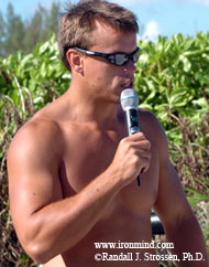 The multitasking Colin Bryce works on his tan while emceeing the 2004 MET-Rx World's Strongest Man contest (Paradise Island, Bahamas). IronMind® | Randall J. Strossen, Ph.D. photo.