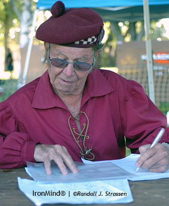 David Webster, OBE, hard at work compiling scores before hitting the field to call the action at the 2008 Pleasanton Highland Games (presented by the Caledonian Club of San Francisco). IronMind® | Randall J. Strossen photo.