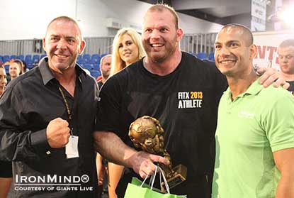 Derek Poundstone (center) is headed to World’s Strongest Man 2013, after winning Giants Live–Melbourne . . . and he did with one arm.  That’s Paulo Freitag (Alkaline Nutrition) on the right and Tony Doherty (FitX promoter) on the left.  Photo courtesy of Giants Live.