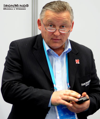 Checking messages: Frank Mantek—the coach behind such weightlifting stars as Ronny Weller, Marc Huster and Matthias Steiner—awaits the beginning of the men’s superheavyweight class at the recent London Prepares: Olympic Weightlifting Test Event.  IronMind® | Randall J. Strossen photo.