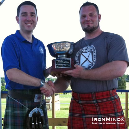 Jonathan Finnie (Vice President, Scottish Games Society of Delaware) presents the first place trophy to Gregor Edmunds.  IronMind® | Photo courtesy of Jonathan Finnie.