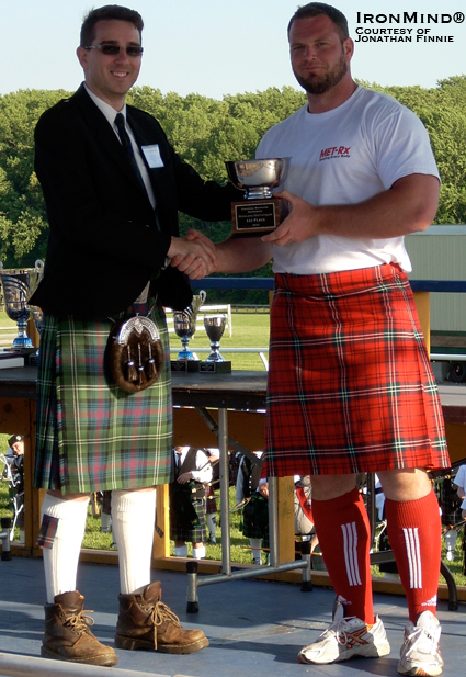 Gregor Edmunds (right) receives his trophy for winning the 2010 Colonial Highland Games (Fair Hill, Maryland) from Jonathan Finnie.  IronMind® | Courtesy of Jonathan Finnie.
