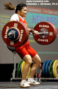 Gu Wei pulling herself under her 139-kg world record clean and jerk, for a junior and a senior world record. IronMind® | Randall J. Strossen, Ph.D. photo.