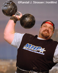 Hugo Girard on his way to ten reps with the replica Inch Dumbbell at the 2005 Arnold. IronMind® | Randall J. Strossen, Ph.D. photo.