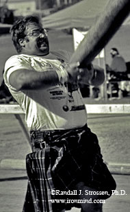 Sticks and stones . . . Steve "Inver Stone" Jeck lays into a caber back in '94 (Pleasanton, California). Welcome to Steve's classroom. IronMind® | Randall J. Strossen, Ph.D. photo.