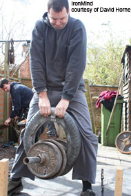 Jim Wylie pinch grips a car tire at the Peter Horne Memorial grip contest (Stafford, England). IronMind® | Photo courtesy of David Horne.