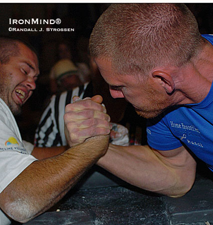 Central California has produced more top arm wrestlers than a lot of countries have, including such guys as Kenny Hughes and Mike McGraw.  Here, Kenny Hughes (left) makes Bryan Johnson’s neck bulge as he tries to separate Bryan’s arm from his shoulder.  IronMind® | Randall J. Strossen photo.