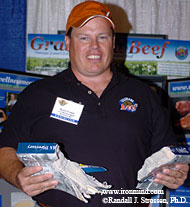 Did Kevin Fulton get frustrated looking up a phone number or was he just having some fun at the Grassland Beef booth at the 2004 GNC Show of Strength? IronMind® | Randall J. Strossen, Ph.D. photo.