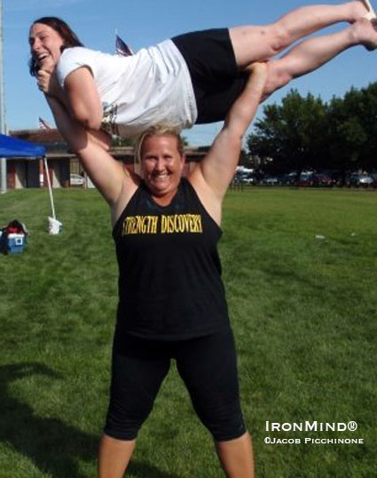 Three-peat heavyweight winner Kristin Rhodes lofts Kelly Picchione, who won the lightweight title.  IronMind® | Jacob Picchione photo, courtesy of Dione Wessels.