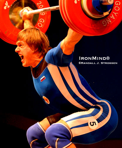 Dmitri Lapikov (Russia) snatches 194 kg in the 105-kg category at the 2009 World Weightlifting Championships (Goyang City, Korea).  Notice Lapikov’s right hand:  It would be virtually impossible to snatch world-class weights without using a hook grip.  IronMind® | Randall J. Strossen photo.