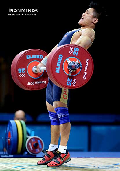 Lu Xiaojun (China) cranks on 175-kg, on his way to breaking the Olympic and the world record in the snatch—he left London’s ExCel Center tonight as the 77-kg Olympic weightlifting champion.  IronMind® | Randall J. Strossen photo.