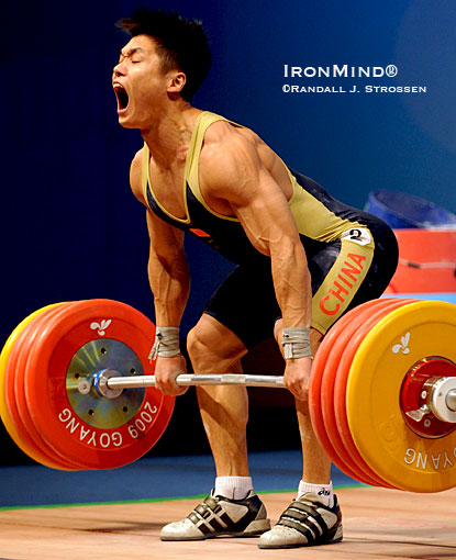 With two world records already in his pocket, Lu Xiaojun starts 211 kg on its way in the 77-kg category at the World Weightlifting Championships.  IronMind® | Randall J. Strossen photo.