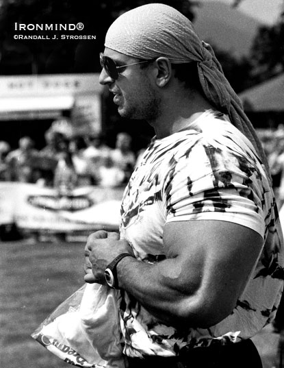 Until you saw him in action, it would be easy to dismiss Manfred Hoeberl as a mere bodybuilder, especially given his prodigiously developed arms, but, in fact, he was a top strongman -displaying power and athleticism, not to mention being a savvy competitor.  Here, Manfred Hoeberl is shown in Scotland in 1994, where he won the European Musclepower Championships one weekend and then the World Musclepower Championships the next weekend.  IronMind® | Randall J. Strossen photo.