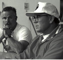 Steve Gough (left) and Mike Burgener (right) are looking pretty serious: In 1991, Mike Burgener came up to the Fairfax Weightlifting Club (San Anselmo, California) to talk training with Steve Gough. Under Steve's leadership, Fairfax was producing such top junior weightlifters as Tom Gough, Jasha Faye, Pete Schiano and Tim Logan, so Mike came up to pick Steve's brain. IronMind® | Randall J. Strossen, Ph.D. photo.