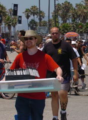 "Grippers . . . get your grippers." Mike Wayne (left) carries in the goodies, so that he and Clay Edgin (right) could have some fun at Muscle Beach this summer. IronMind® | Randall J. Strossen, Ph.D. photo.