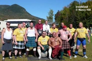 Highlander Games athletes/judges/sponsors. Left to right. Magnus Ver Magnusson, Benedikt Magnusson, Sam McMahon, Jim Glassman, Mike Zolkiewicz, Dan Ford, Dave Barron, Wout Zijlstra, Gerard Benderoth, Derek Hurley, Gregor Edmunds, with sponsors Ray and Cinda D'Amante sitting on the boxes. IronMind® | Photo by Nancy Hill, courtesy of Dr. William Crawford.