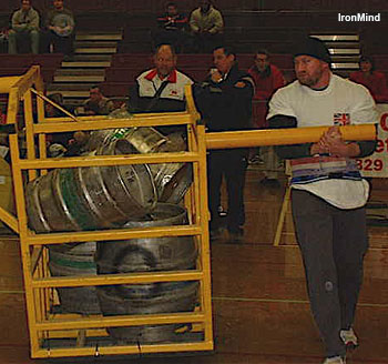 Nick McKinless strolling with the 300-kg Conan's Wheel, on his way to victory in the 2006 Britain's Strongest Man under 105 kg. IronMind® | Photo courtesy of Nick McKinless.