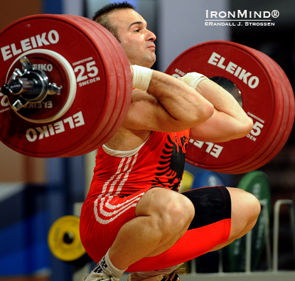 Erkand Qerimaj hits the bottom with 190 kg on his third attempt, jerking the weight for the 77-kg title at the 2012 European Weightlifting Championships.  IronMind® | Randall J. Strossen photo.