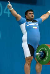 Hossein Rezazadeh celebrates his successful opening snatch at the 2004 Olympics (Athens). If there is anyone who makes a 200-kg snatch look light and easy, it is this man. IronMind® | Randall J. Strossen, Ph.D. photo.