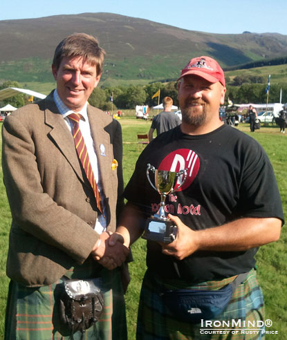 Ewan Cameron presents the trophy to winner Rusty Price, winner of the SHGA British Highland Games Championships.  IronMind® | Photo courtesy of Rusty Price.