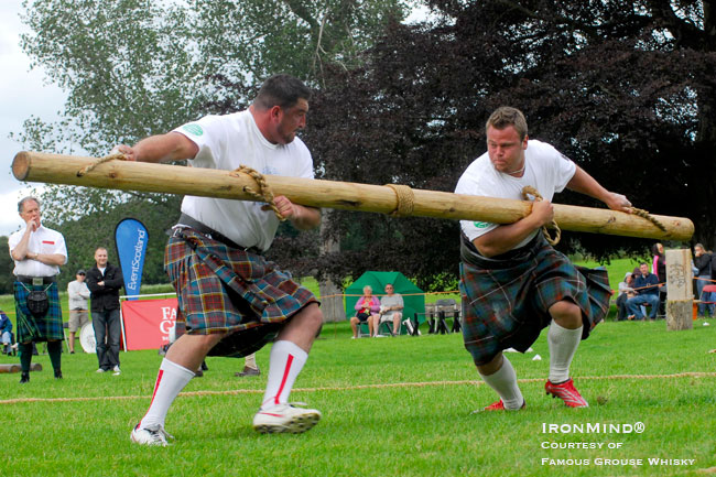 The Pole Push, shown here with Sebastian Wenta (left) and Johannes Arsjo (right), typifies the sort of challenge Douglas Edmunds has built into his Highlander concept.  IronMind® | Photo courtesy of Famous Grouse Whisky.