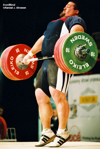 Shane Hamman (USA) ripping a 197.5-kg snatch at the 2002 World Weightlifting Championships (Warsaw, Poland). Shane holds the US super heavyweight records in the snatch, the clean and jerk, and the total; plus he holds the IPF super heavyweight world record in the squat . . . each of these lifts was done under the strictest conditions in the field. IronMind® | Randall J. Strossen, Ph.D. photo.