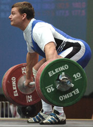 Vladimir Smorchkov (Russia) starts 195 kg on its split-second ride from the platform to overhead, winning the first of his three gold medals today. IronMind® | Randall J. Strossen, Ph.D. photo.