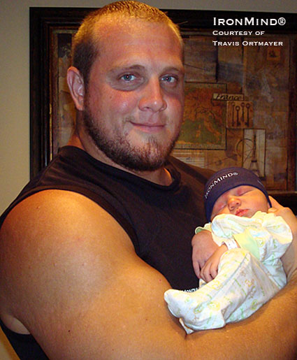 Travis Ortmayer and “The Prince of Stones,” who we would respectfully also dub, “Mighty Mitts.”  Check out the hands on this little guy.  Good taste in headwear, too.  IronMind® | Photo courtesy of Travis Ortmayer.