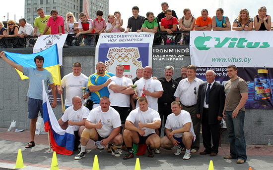 Athletes, organizers and such dignitaries as Olympic weightlifting champion Leonid Taranenko gather for a group photo at the first stage of the 2010 Belarus Strongman Cup.  IronMind® | Photo courtesy of Vlad Redkin.