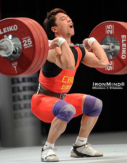 After racking this 176-kg third attempt clean and jerk, Zhang Jie is on his way back up—he made the jerk and won the class.  IronMind® | Randall J. Strossen photo.