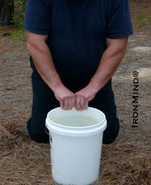 Want to be able to bend or tear coins?  Build your finger and pinch grip strength with John Brookfield's Bucket Work exercise.  Here John uses a 5-gallon bucket filled with water for the exercise, giving his fingers a tremendous workout.  Note the positioning of his hands together with thumbs facing his body.  IronMind | Photo courtesy of John Brookfield.